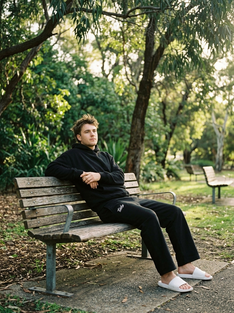 OG Sweatpants White Logo — male park bench lifestyle
